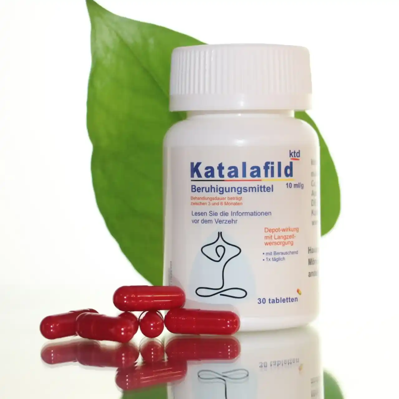 کاتالافیلد دوز 10 میلی گرم با کپسول های قرمز روی سطح شیشه ای و یک برگ سبز پشت عکس قرار دارد